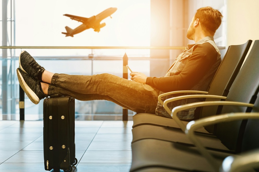 A man looking at a plane